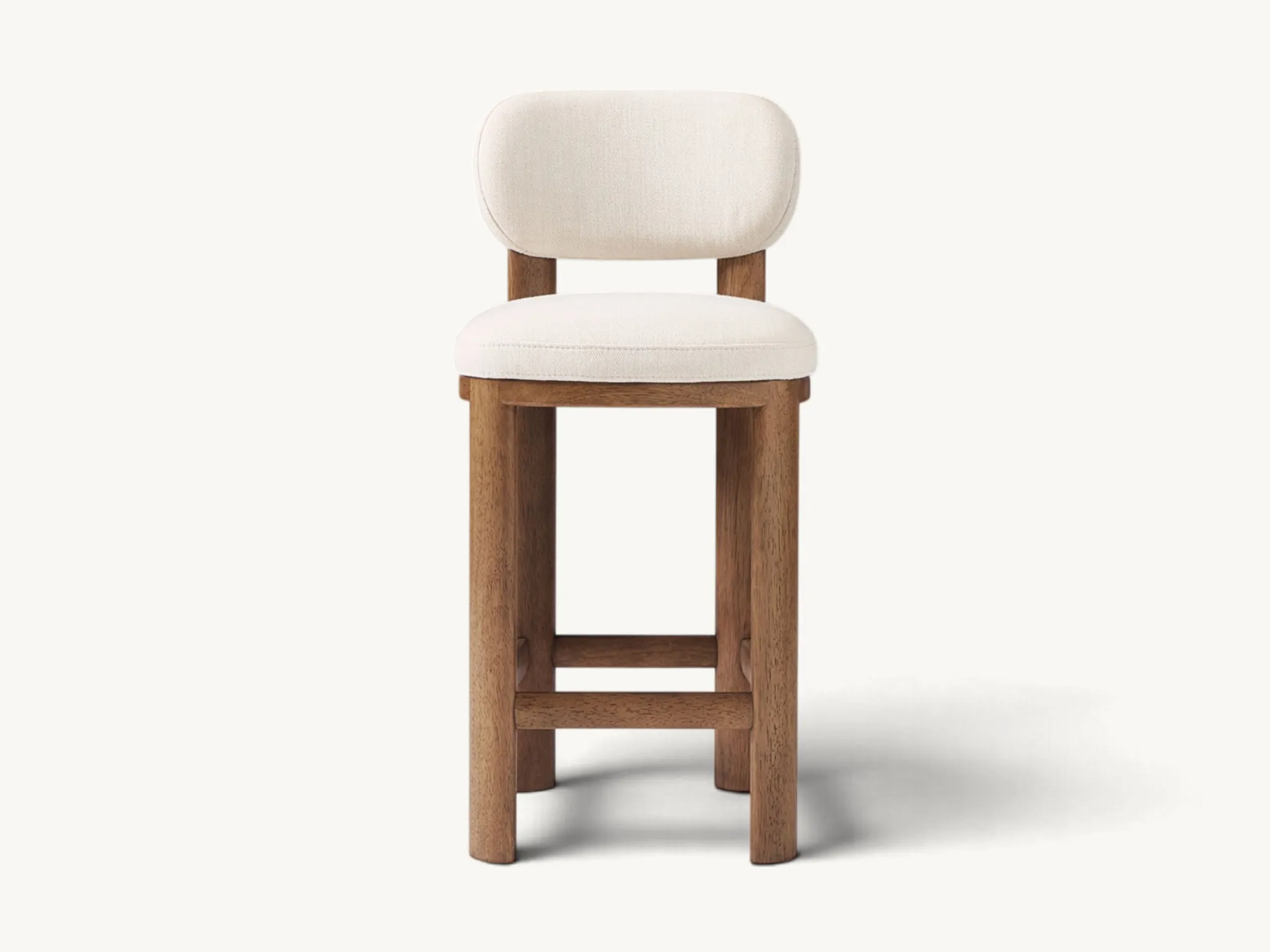 Wooden counter stool with cream fabric upholstered seat and curved low backrest