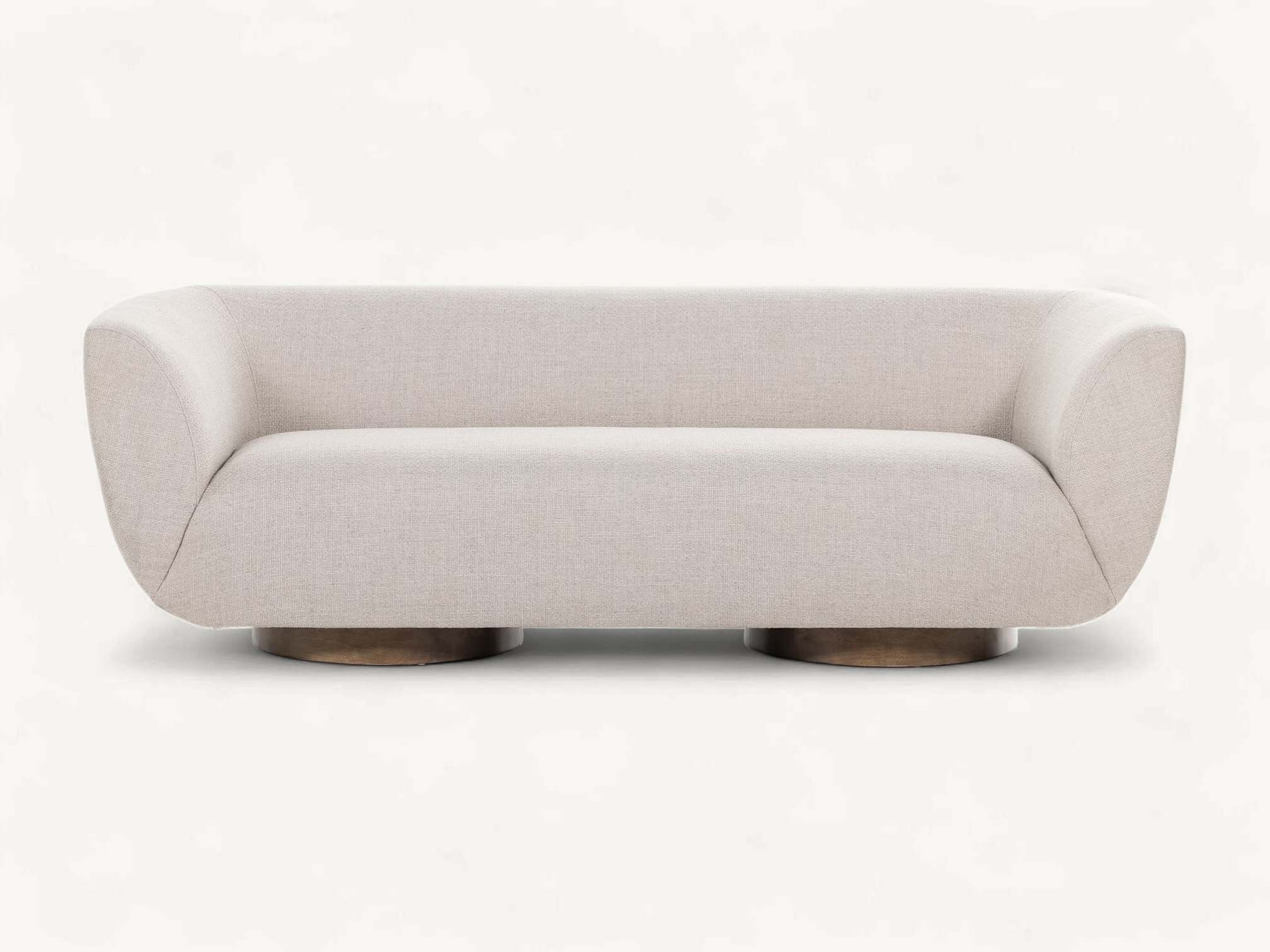 Modern curved sofa with light beige upholstery and circular teak wood pedestal base.