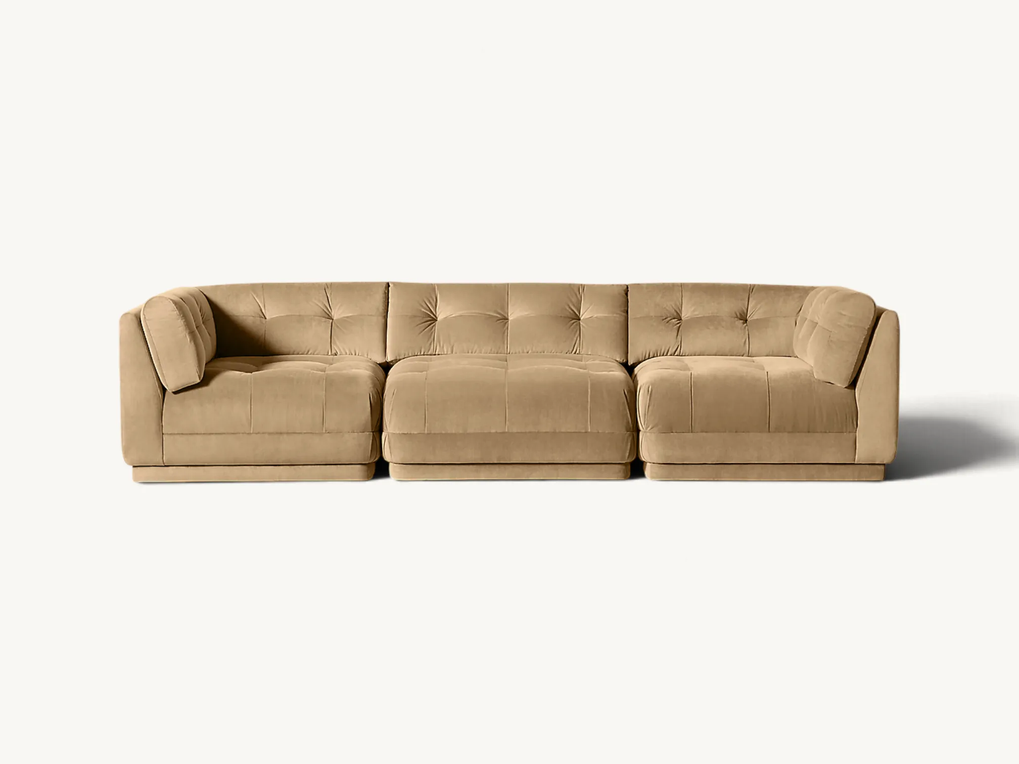 Three-piece modular sectional sofa in beige velvet with subtle tufting details