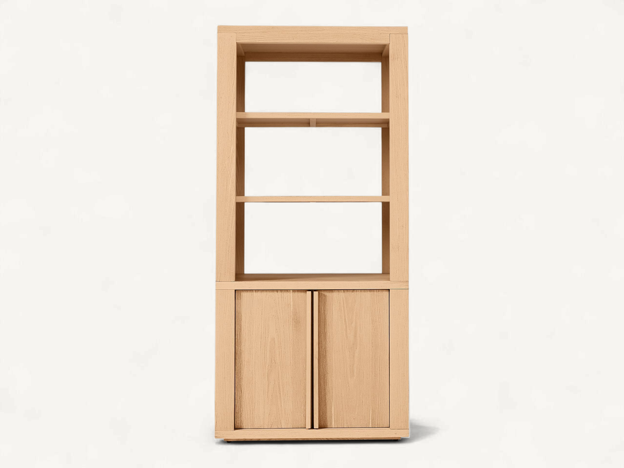 Minimalist tall teak wood bookshelf with open upper shelving and a closed double-door base cabinet featuring seamless vertical handles.