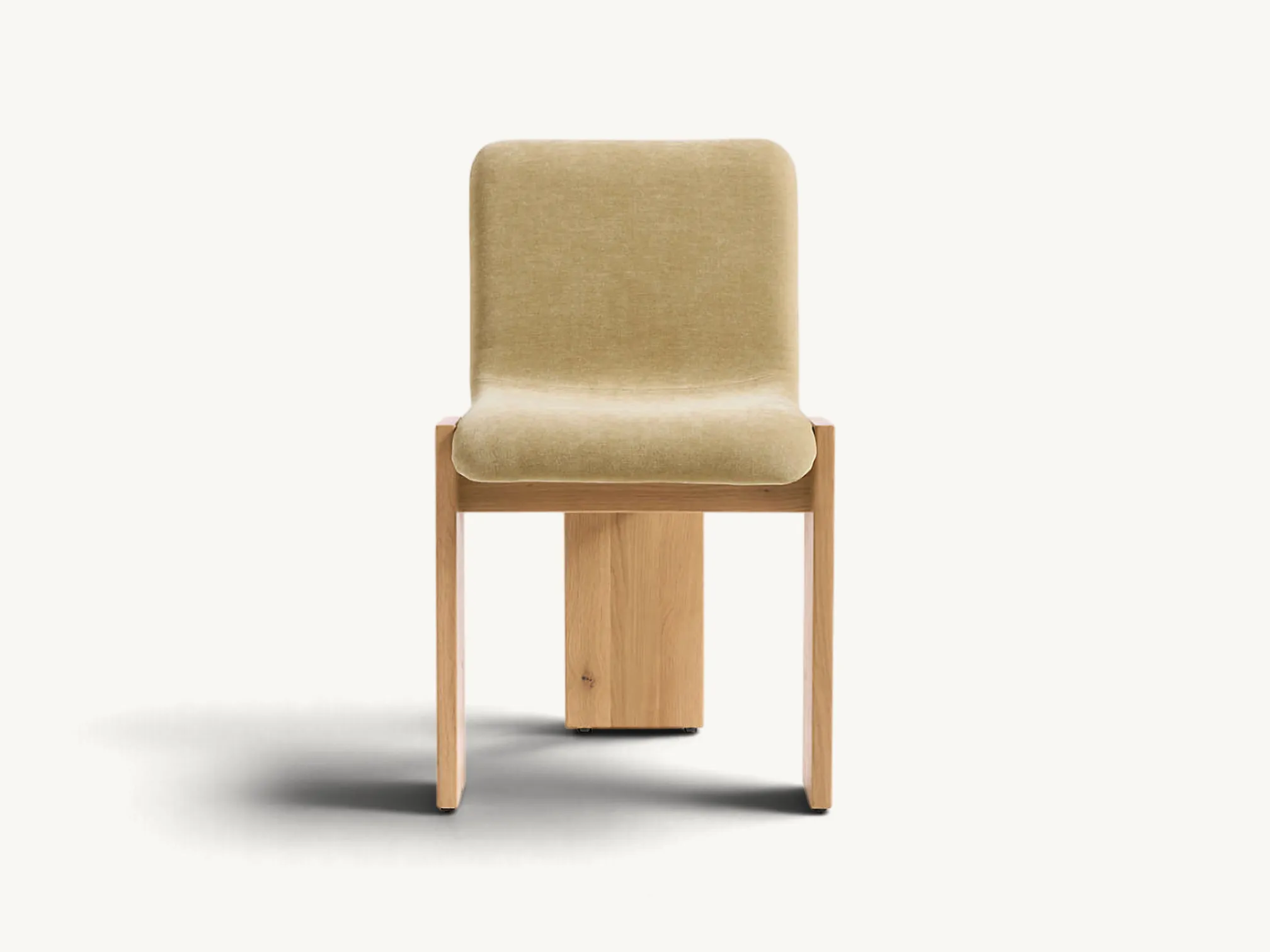 Modern upholstered dining chair with thick solid wood block legs, neutral beige fabric seat, and exposed joinery details