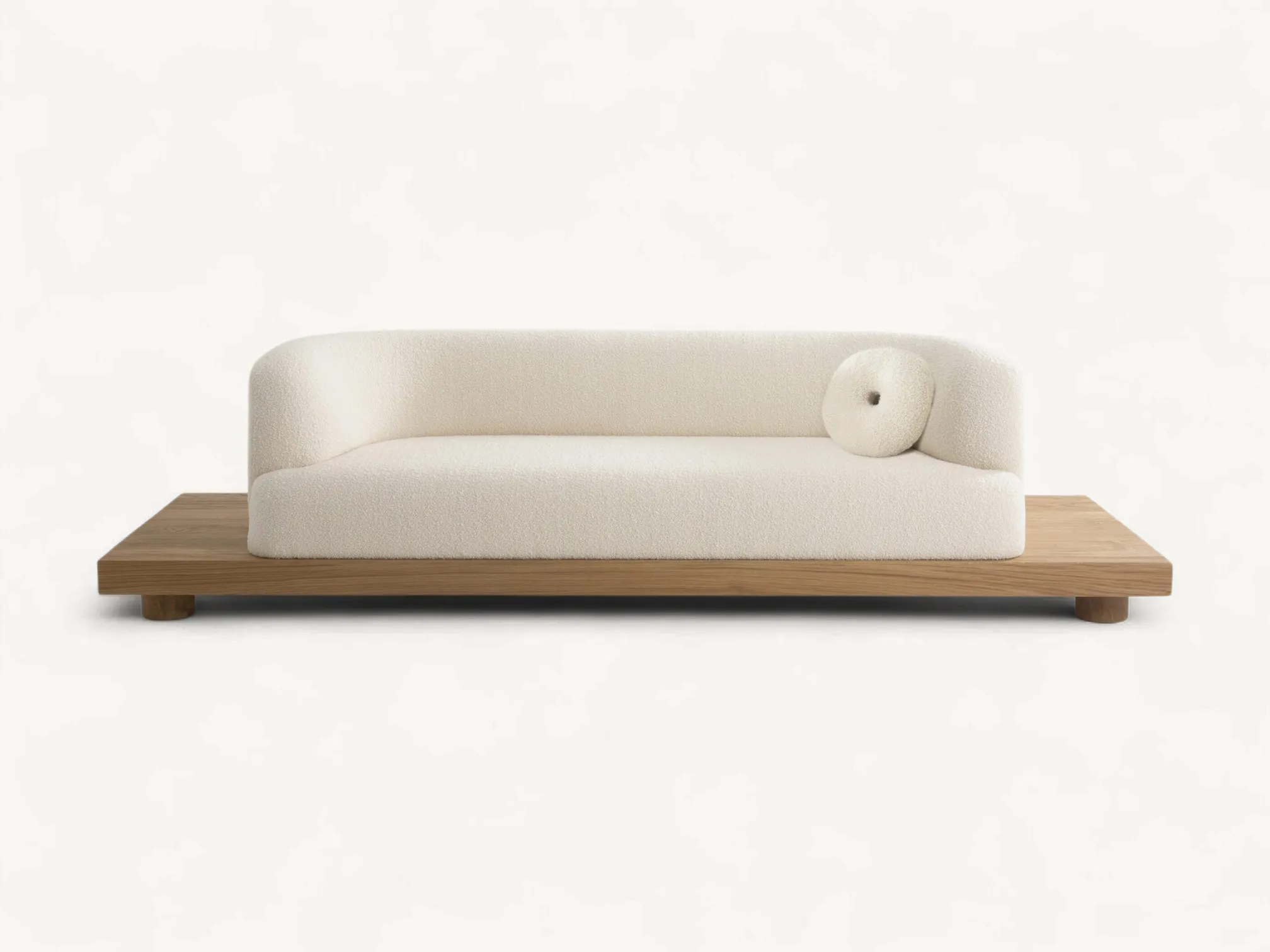 Minimalist curved bouclé sofa on a low-profile solid teak wooden platform.