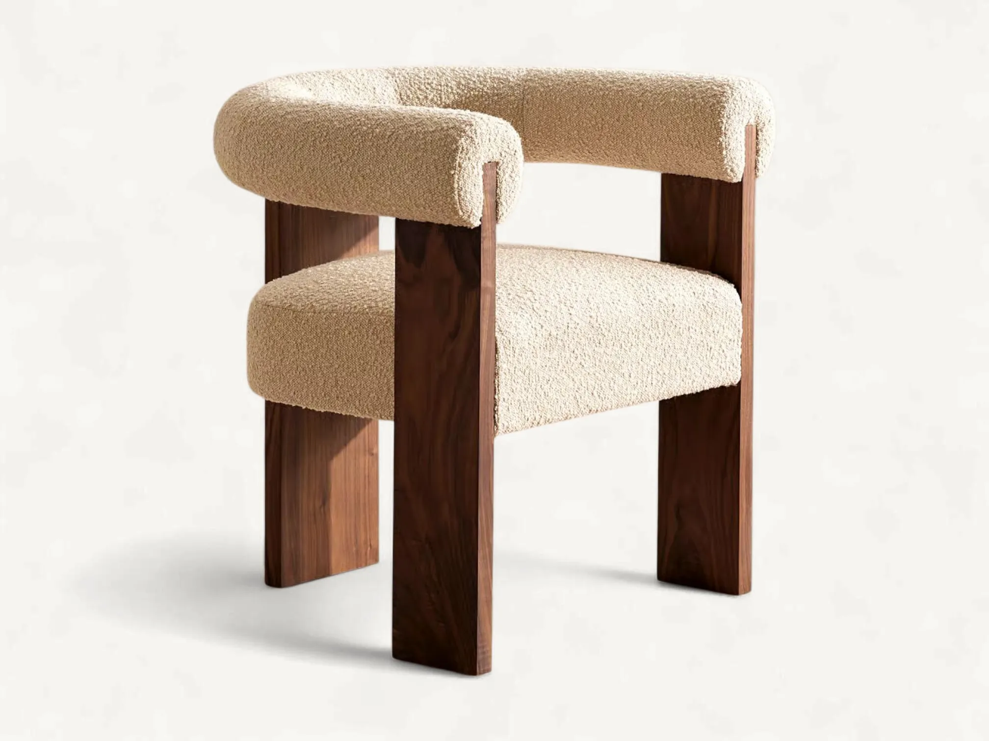 Modern dining chair featuring solid teak wood frame with wide flat legs and a curved cream bouclé upholstered backrest and seat.