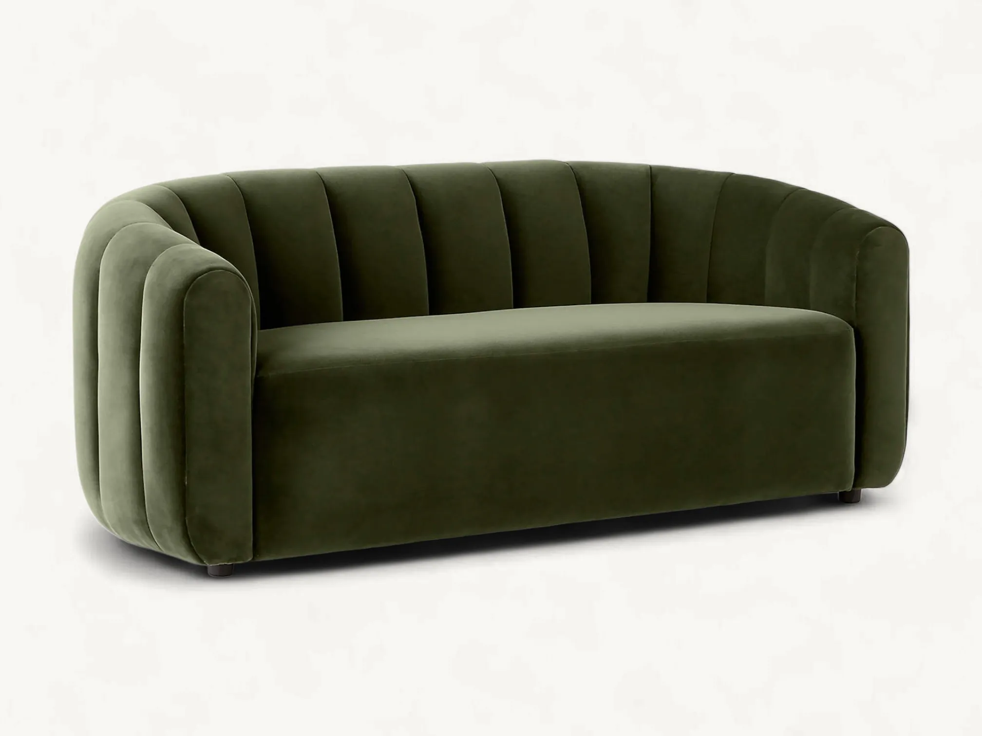 Curved olive green velvet sofa with wide vertical channel tufting and a rounded contemporary design.