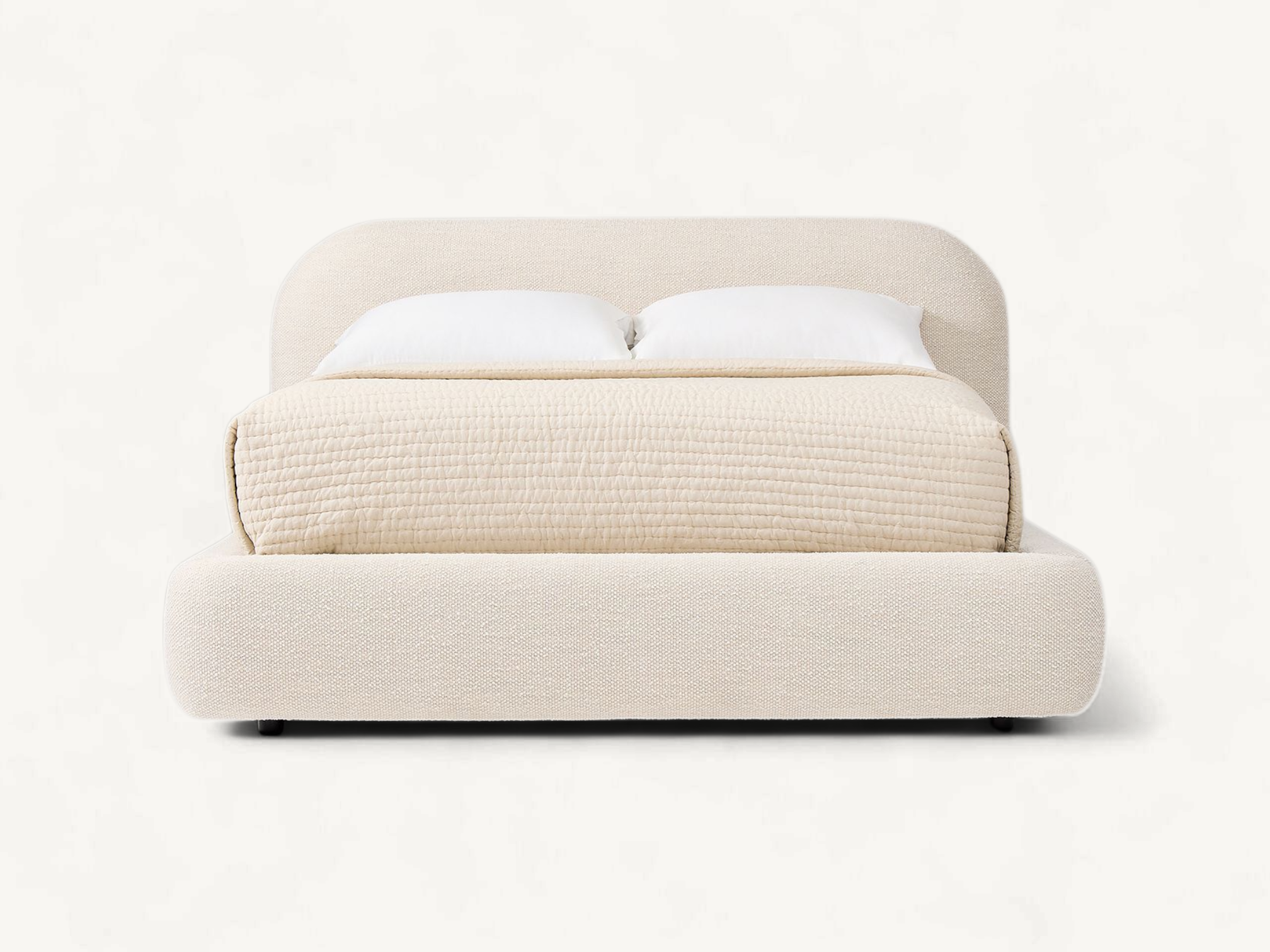Modern fully upholstered platform bed in cream fabric with rounded headboard and teak wood internal frame.