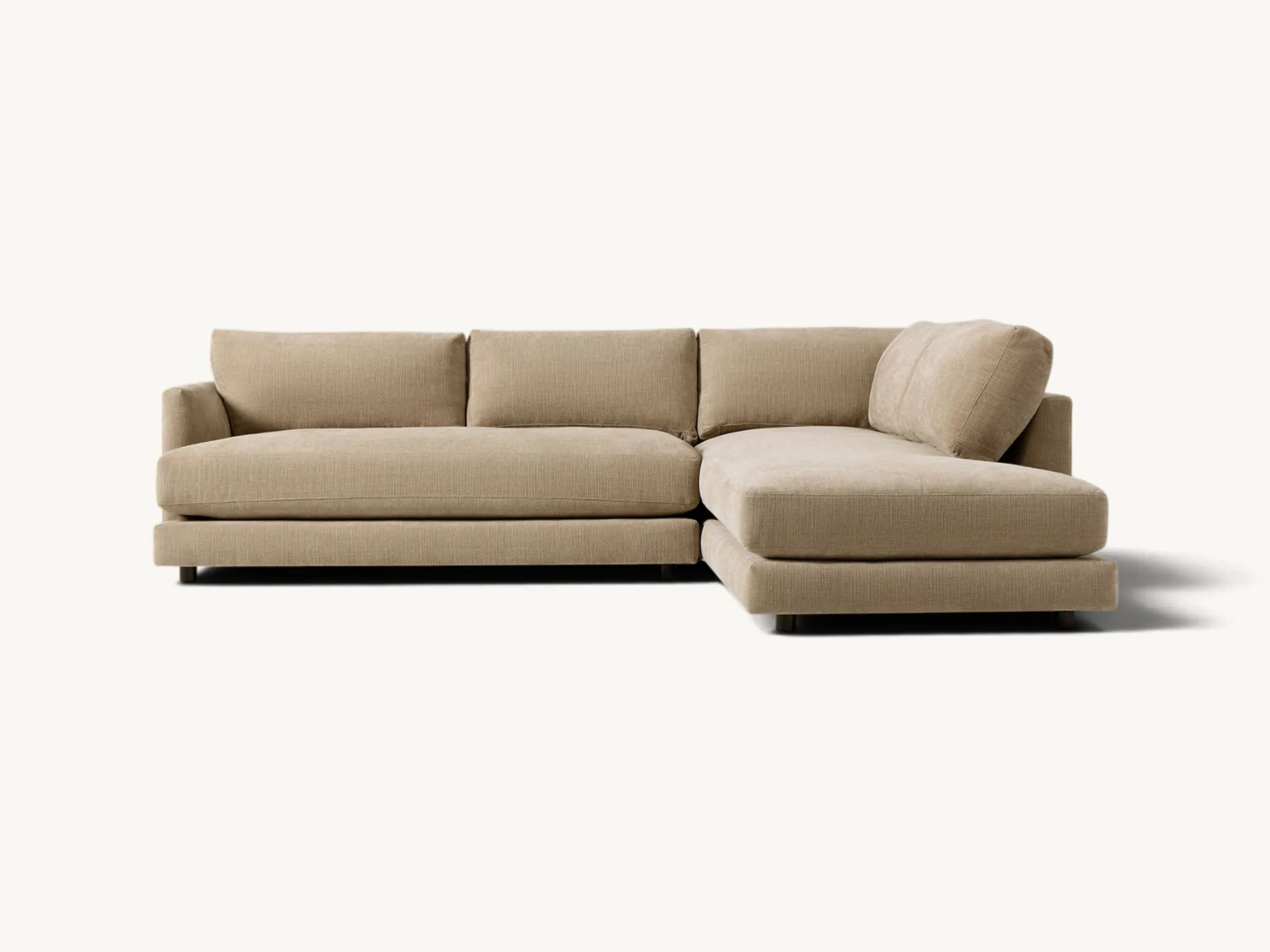 Modern beige L-shaped two-piece sectional sofa with deep cushions and integrated chaise lounge section