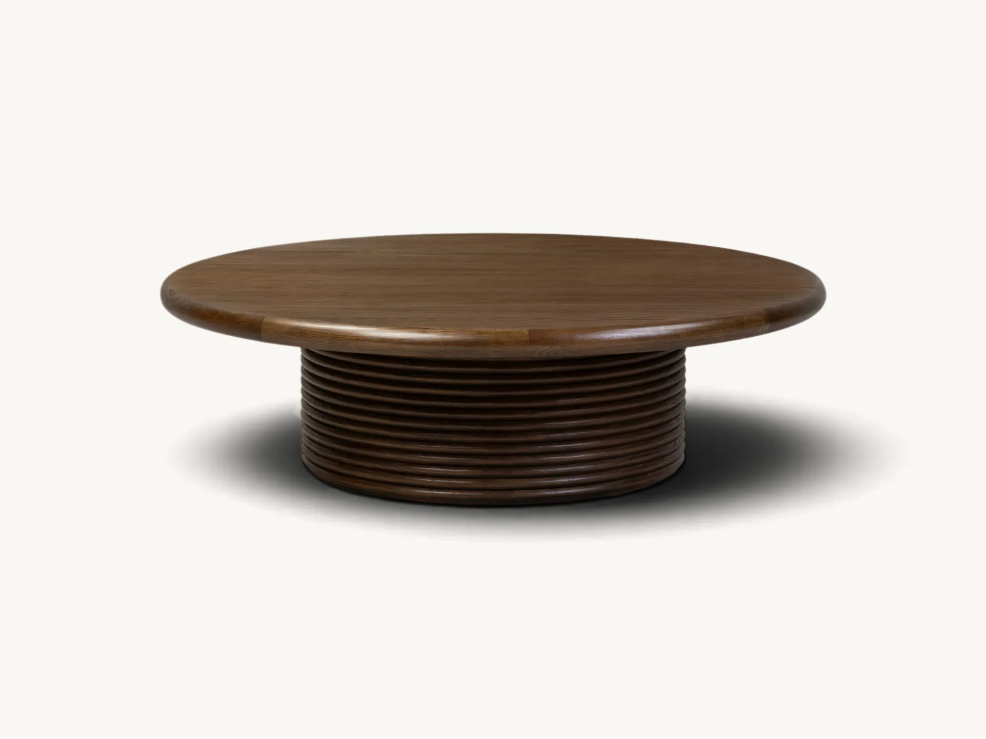 Round wooden coffee table featuring a fluted reeded pedestal base in dark brown wood finish
