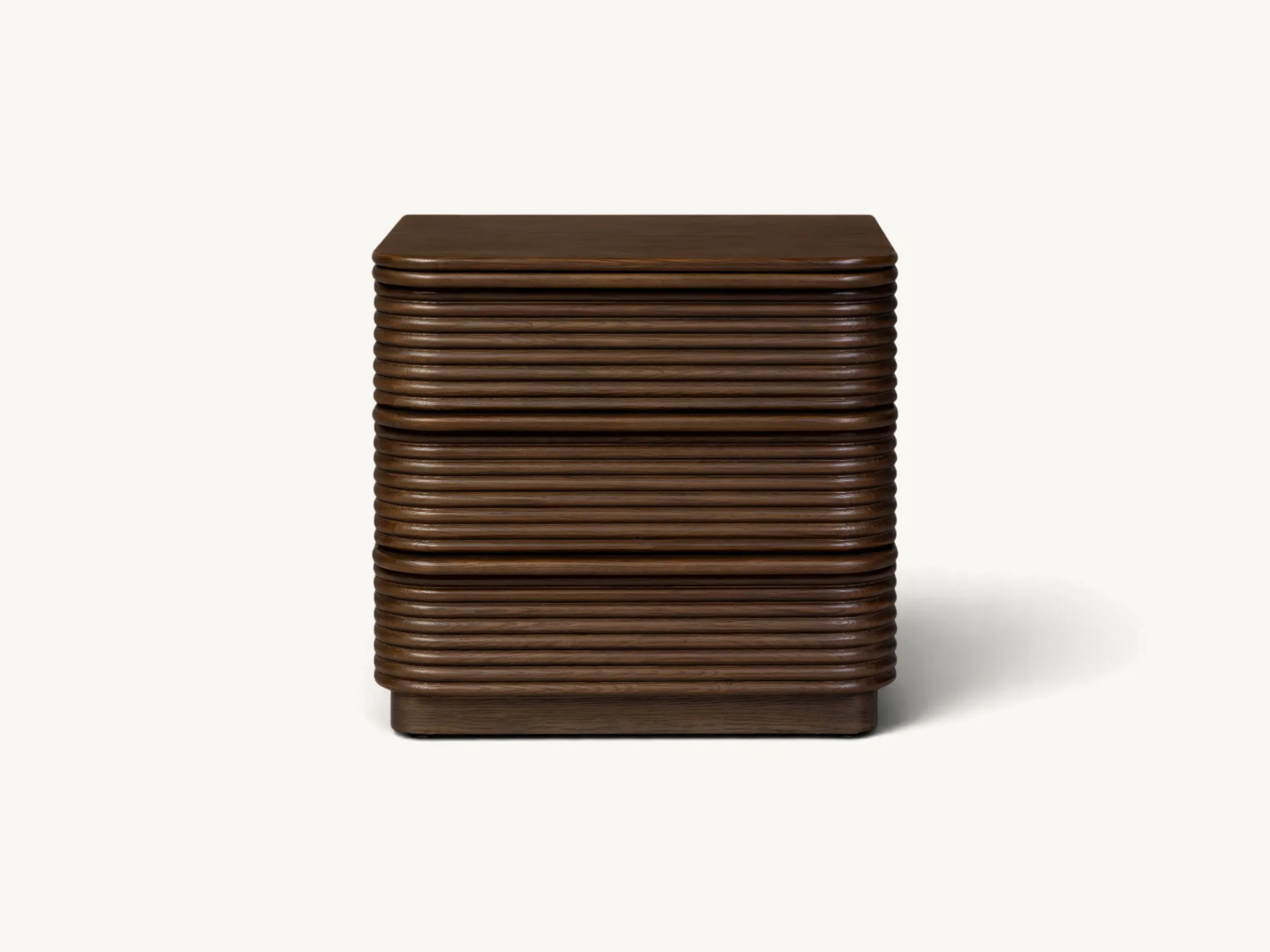 Wooden three drawer nightstand with reeded fluted detailing and rounded corners in dark brown wood finish