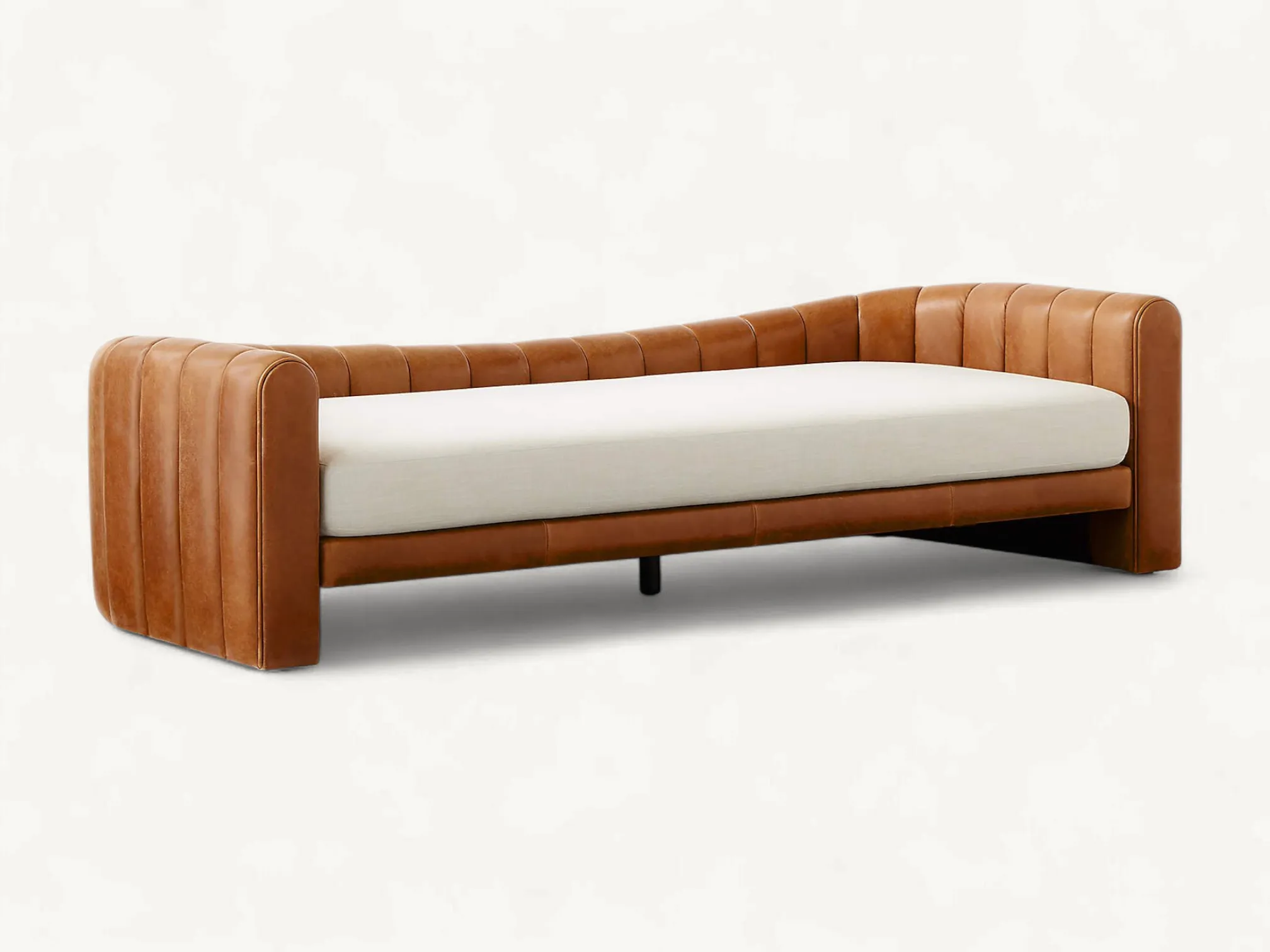 Curved leather daybed with vertical channel tufting and teak wood frame base.