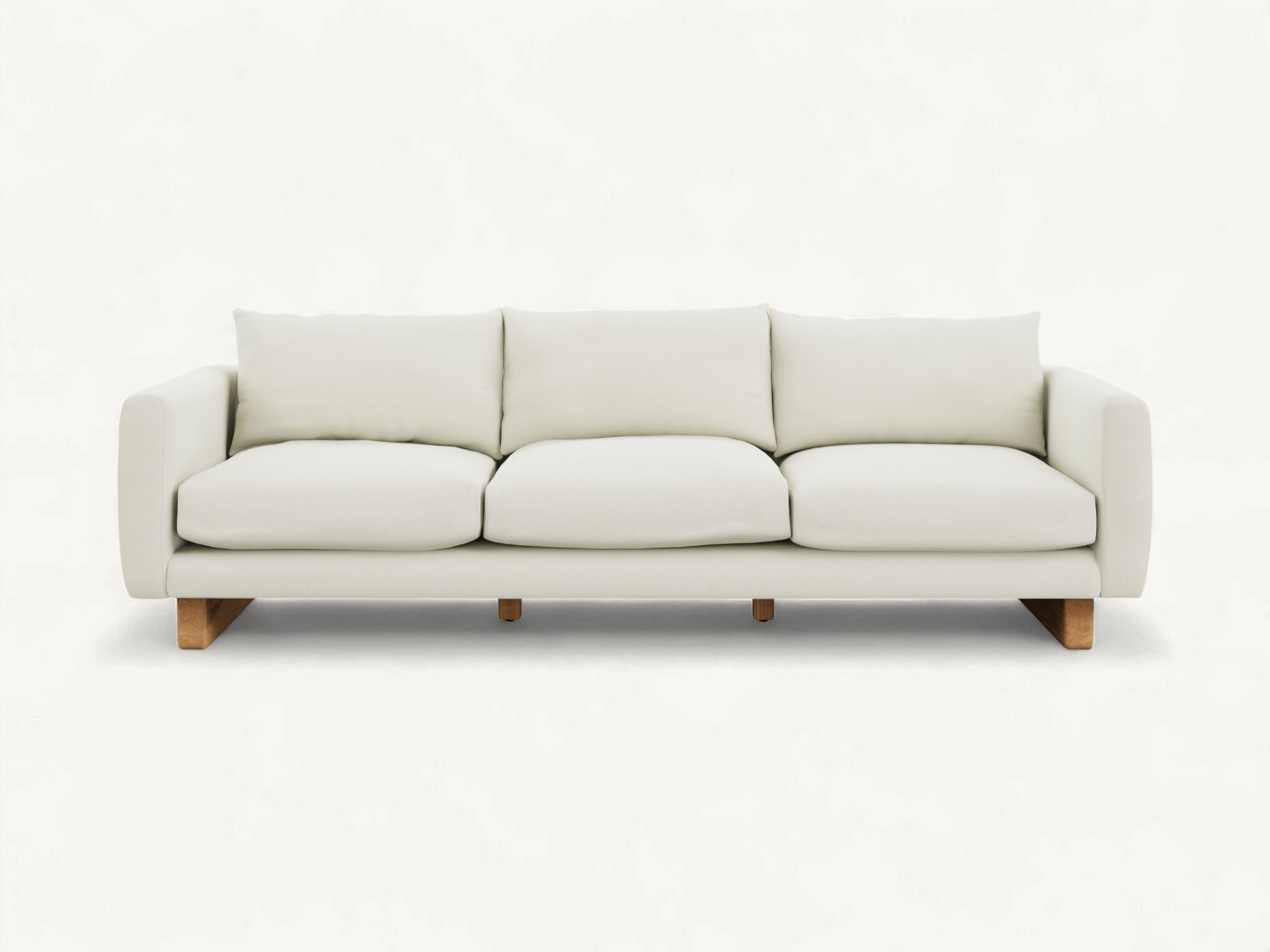 Scandinavian style 3-seater sofa in cream fabric with exposed natural teak wood legs and plush cushions.