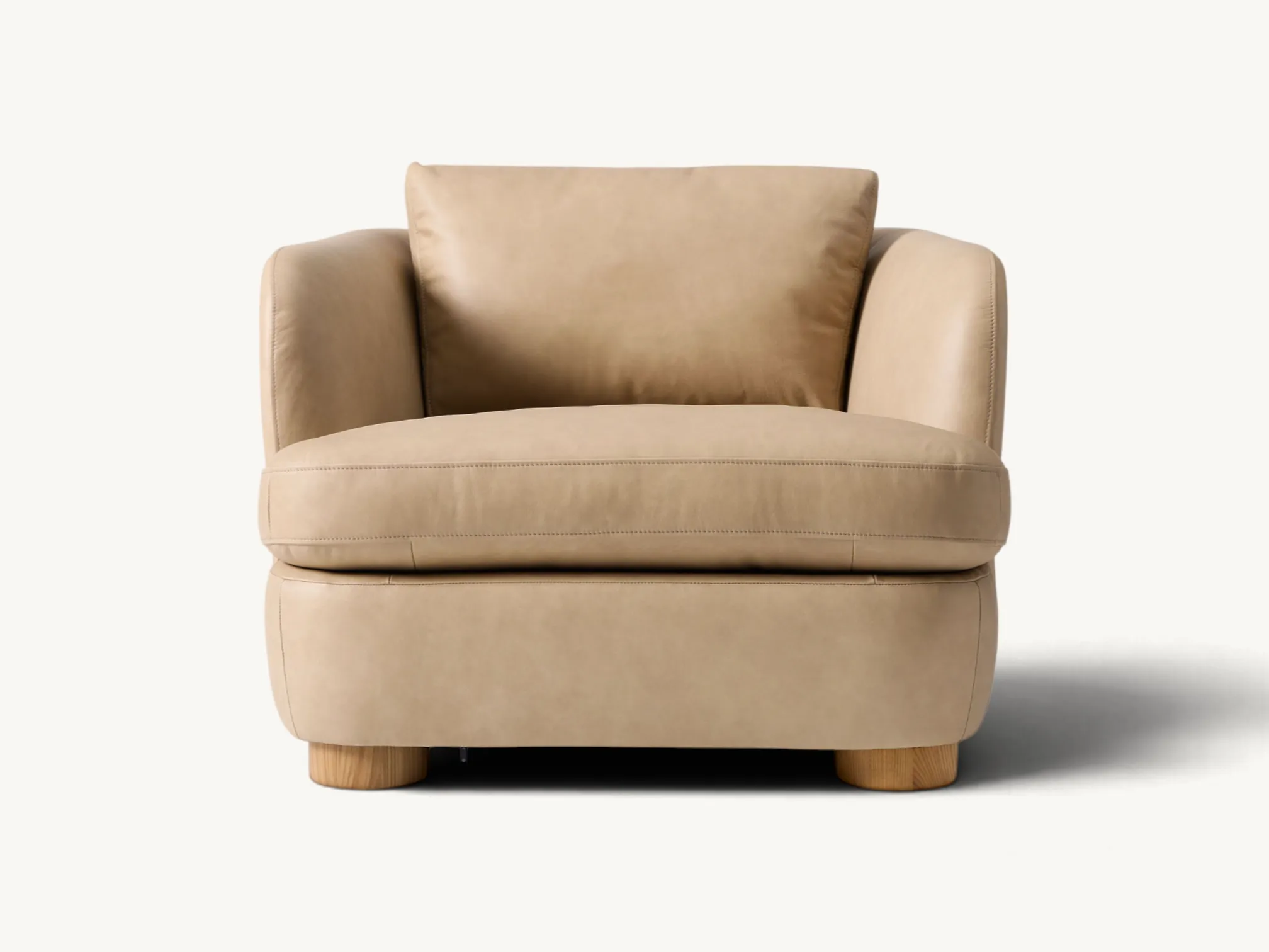 Single leather armchair in beige with thick round natural wooden legs