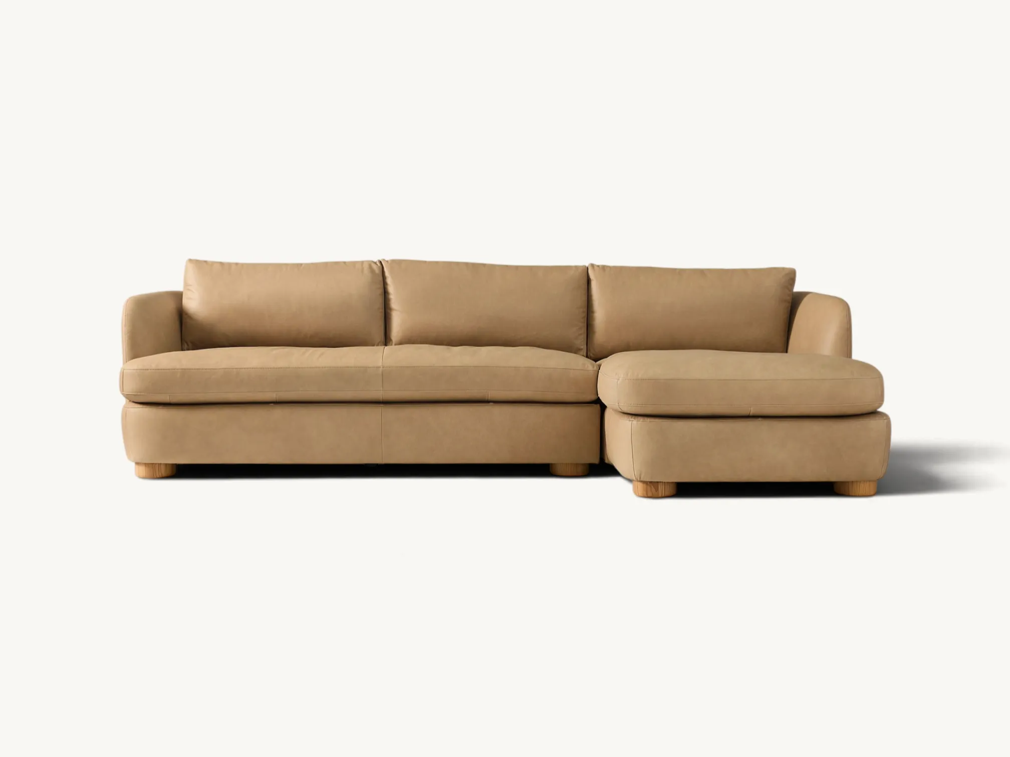 Two-piece leather sectional chaise sofa in beige with natural round wooden legs
