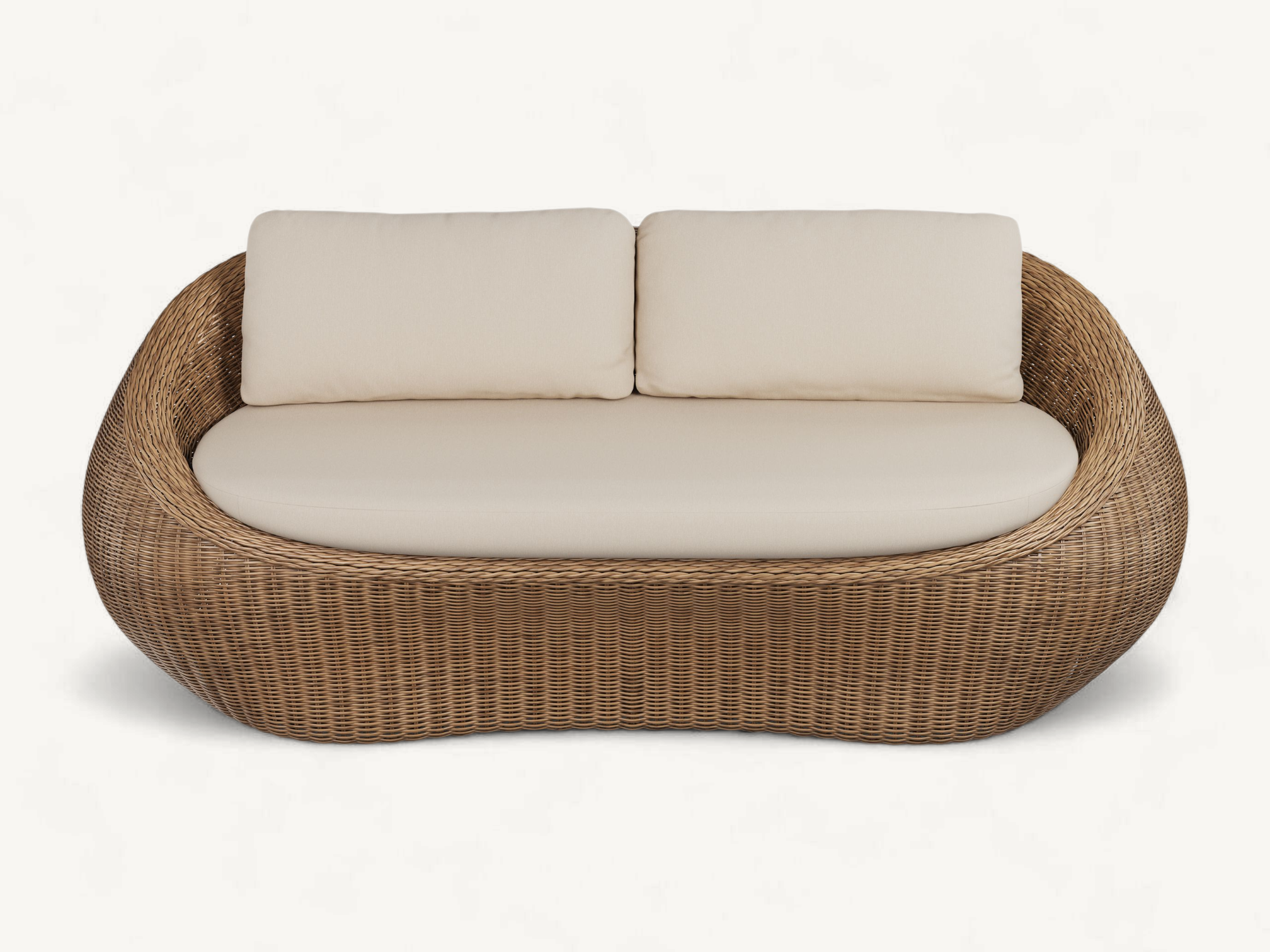 Organic curved outdoor sofa made of full natural rattan with plush cream cushions.