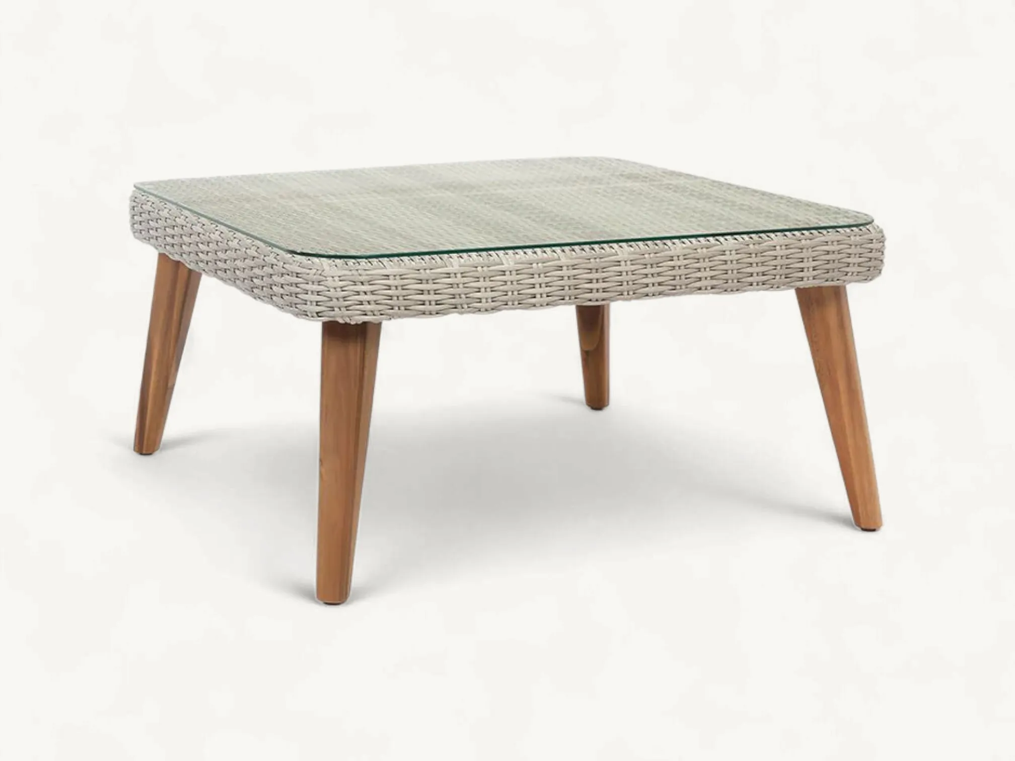 Scandinavian outdoor coffee table made of rattan with a slatted top and a functional bottom storage shelf.