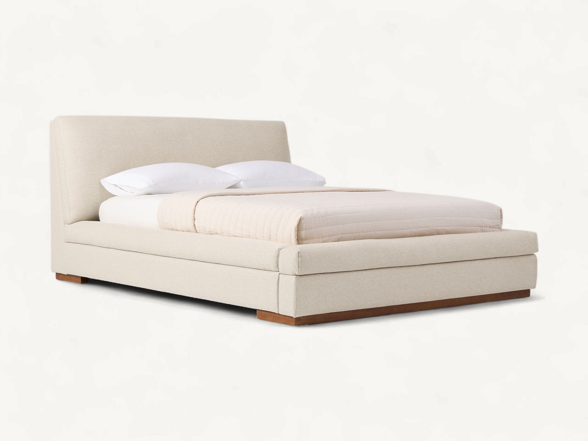 Solid wood mid-century platform bed with tapered flared legs, an angled open-back headboard holding two thick button-tufted gray fabric cushions, and an integrated wood slat support system.