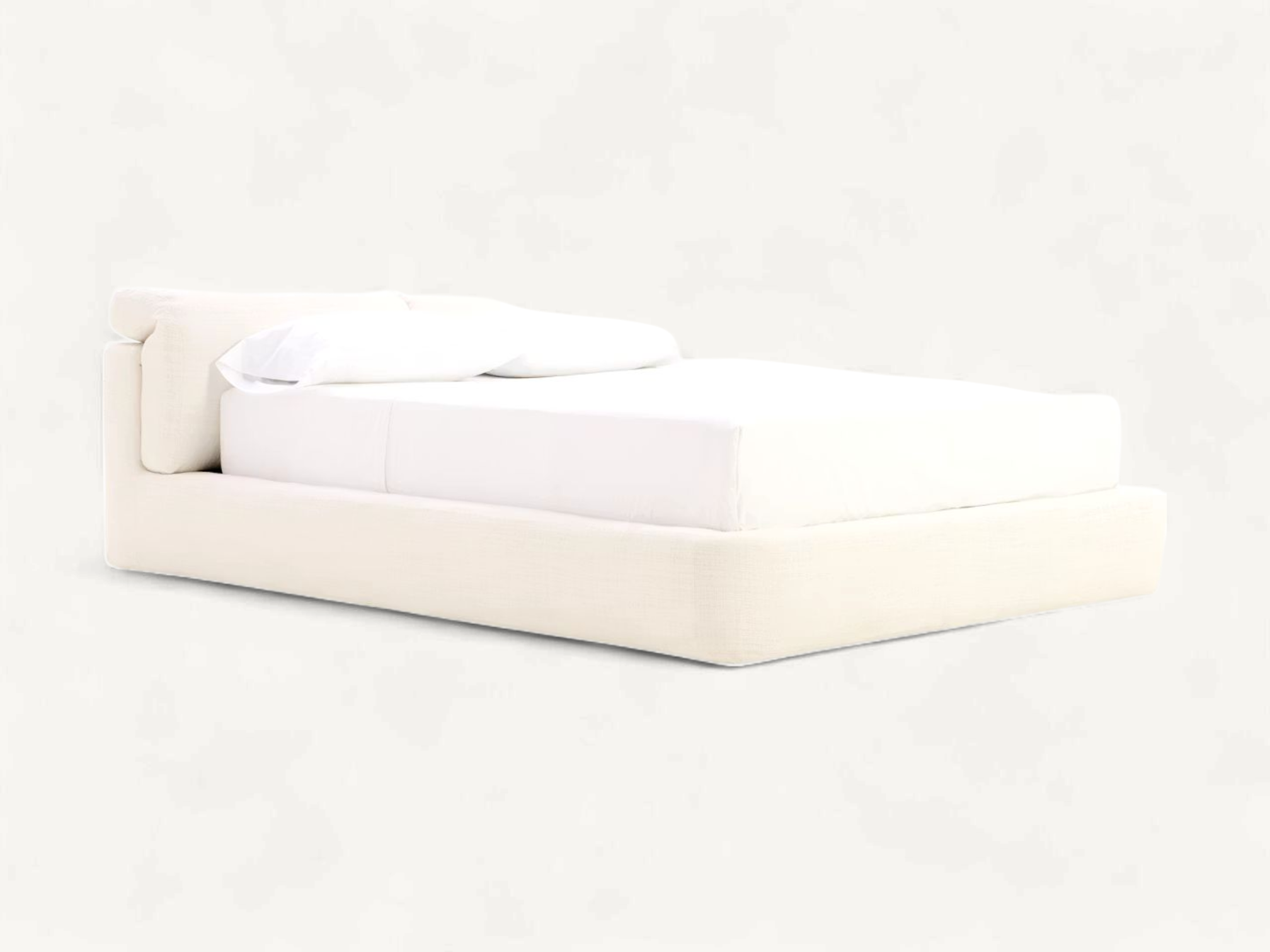Low-slung upholstered platform bed in off-white textured fabric, showcasing a unique twin pillow-style headboard shown in both folded-down and extended upright positions.
