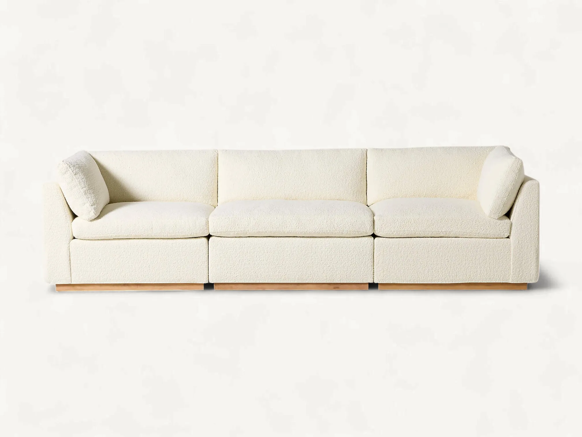 Modern three-piece modular sofa with a boxy minimalist design, white textured upholstery, and a slim solid teak wood base.